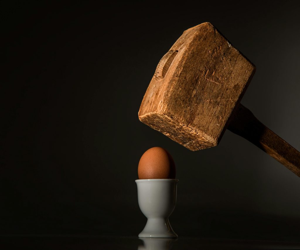 An egg next to a hammer, showing how someone might feel when having vulnerability in recovery.