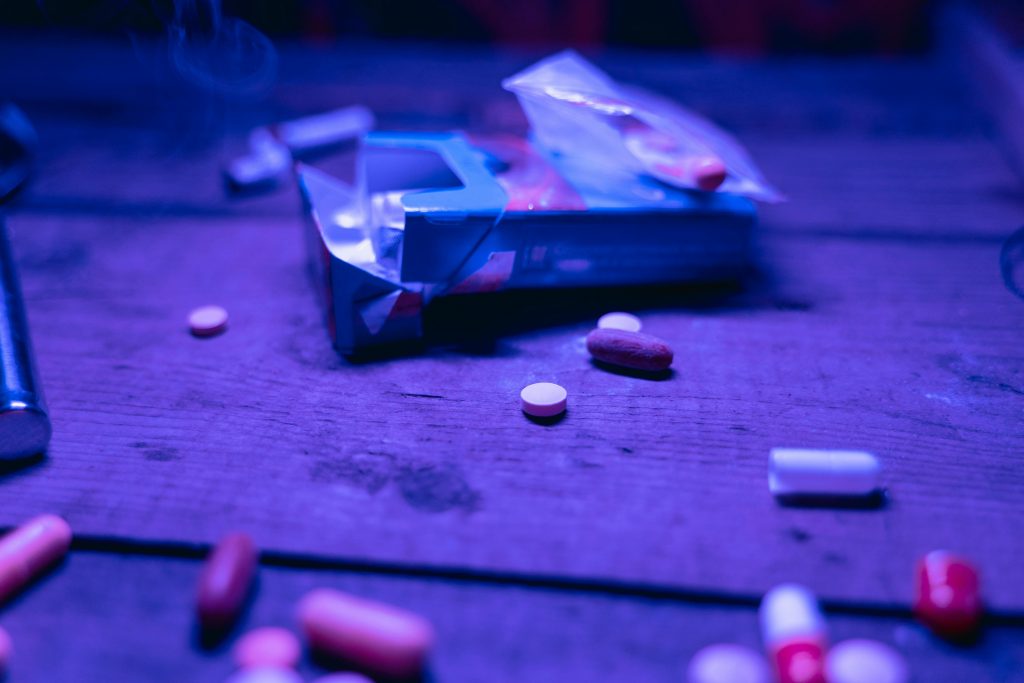 Pills and drugs on a table, indicating that someone is not beating meth addiction right now.